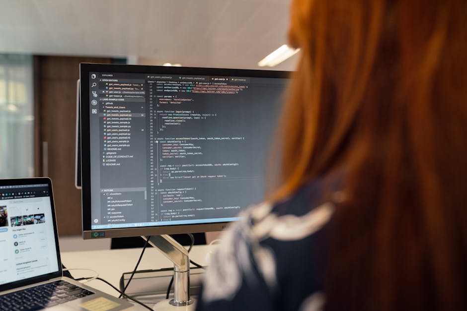 A female engineer works on code in a contemporary office setting, showcasing software development
